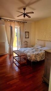 a bedroom with a bed and a ceiling fan at Fontecorona Bed and Breakfast in Serra San Quirico
