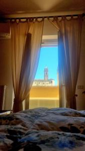 a bedroom with a window with a view of a building at Fontecorona Bed and Breakfast in Serra San Quirico