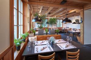 a dining room with a table and chairs and tablesktop at Le Mont-Vully - Hôtel Restaurant in Haut-Vully