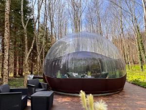 a glass dome sitting on top of a patio at Logement insolite "Bubble jungle" in Saint-Évarzec