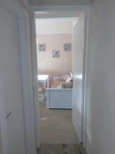 a hallway leading to a bedroom with a bed at IOKASTI STUDIOS 5 in Andros