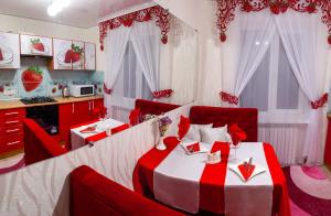 a red and white room with a bed and a kitchen at Luxury apartment Sicheslavska street in Kryvyi Rih