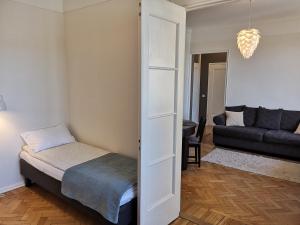 a small bedroom with a bed and a couch at Gonsiori 3 Tenors Apartment in Tallinn