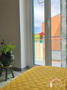 a bedroom with a bed and a window with a plant at Patty Maison - Large & New Central Apartment in Bari