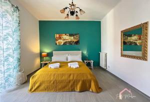 a bedroom with a yellow bed with a green wall at Patty Maison - Large & New Central Apartment in Bari