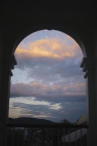 a view of the sky through a window at Shunli Hotel - SHA Extra Plus in Phuket