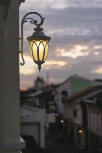 a street light attached to the side of a building at Shunli Hotel - SHA Extra Plus in Phuket Town