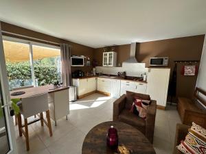a kitchen and living room with a couch and a table at Le Bastidon in Sanary-sur-Mer