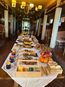 a long table with food on it in a room at Agriturismo Trerè in Faenza