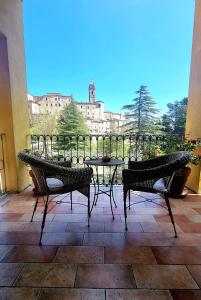 a patio with a table and chairs and a view of a city at Fontecorona Bed and Breakfast in Serra San Quirico