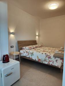 a bedroom with a bed and a table with a red appliance at Casa Castegner - Rooms in Seren del Grappa