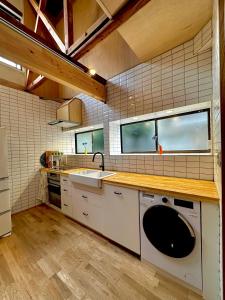 a kitchen with a sink and a washing machine at Spacious 80m2 Private House, central Tokyo in Tokyo