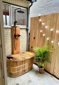 a wooden bath tub sitting next to a wooden wall at Spacious 80m2 Private House, central Tokyo in Tokyo
