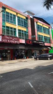 a building with a car parked in front of it at Ada Hotel & Apartment in Kuala Terengganu