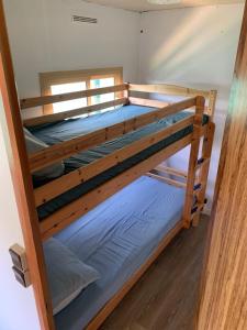 a couple of bunk beds in a room at Calme - détente - proche lac in Biscarrosse