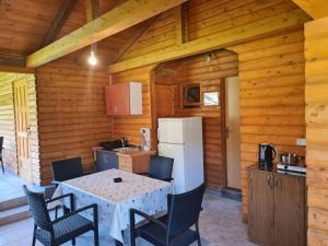 a kitchen with a table and chairs in a cabin at Flora&Fauna in Bihać