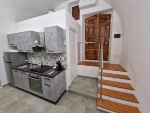a kitchen with a sink and a stove top oven at Cavour Numero Venti in Bernalda
