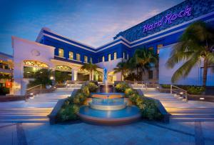 a hotel with a fountain in front of a building at Hard Rock Hotel Riviera Maya- Heaven Section (Adults Only) All Inclusive in Puerto Aventuras