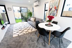 a living room with a table and chairs at Sunsoaked seaside 1 bedroom 1 bath in Christchurch