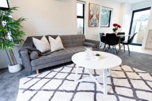 a living room with a couch and a table at Sunsoaked seaside 1 bedroom 1 bath in Christchurch