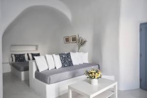 a living room with a couch and a table at Fava Eco Suites in Oia