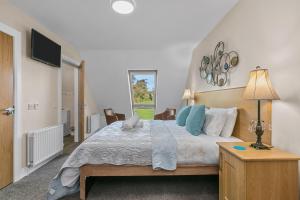 Postel nebo postele na pokoji v ubytování Tollyrose Country House