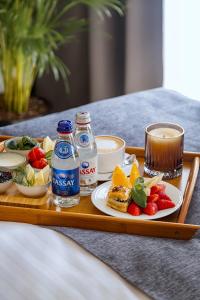 a tray of food with drinks and fruit on a table at Rasoda Hotel&Restaurant in Tashkent +49 photos