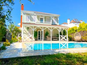 a villa with a swimming pool in front of a house at Villa Kayi Kottage in Peaceful calis few minutes from Çaliş sunny Beach in Fethiye