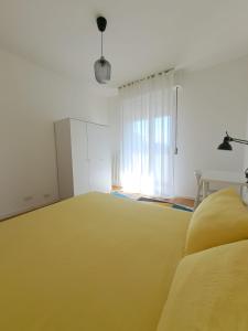 a room with a large yellow bed and a window at San Paolo's Room in Milan