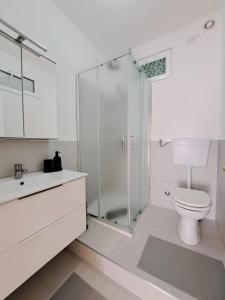 a bathroom with a shower and a toilet and a sink at San Paolo's Room in Milan