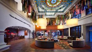 a lobby with a large ceiling with a stained glass window at Hard Rock Hotel Riviera Maya - Hacienda All Inclusive in Puerto Aventuras