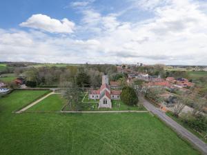 an aerial view of a house in a green field at Bettys House in Great Ryburgh