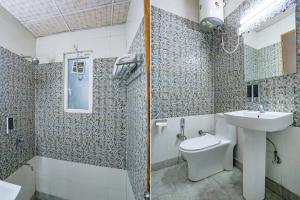 a bathroom with a sink and a shower and a toilet at FabHotel F9 Peeragarhi in New Delhi