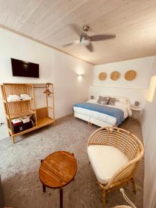 a bedroom with a bed and a couch and a table at Casa Di Manto Traditional Apartment in Mýkonos City