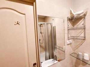a bathroom with a shower and a toilet and a sink at Dainas 2-room Apartment - Arena Riga in Riga