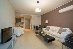 A television and/or entertainment centre at Lovely New Βuild Flat Near Metro - Free Parking