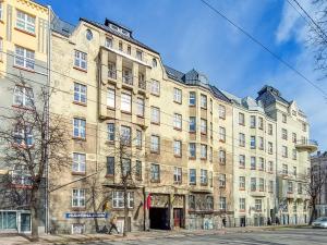 a large building on the corner of a street at Dainas 2-room Apartment - Arena Riga in Riga