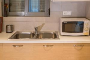 A kitchen or kitchenette at Lovely New Βuild Flat Near Metro - Free Parking