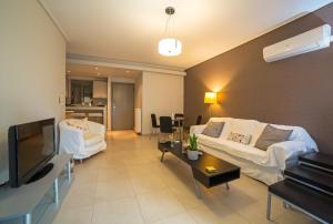A television and/or entertainment centre at Lovely New Βuild Flat Near Metro - Free Parking