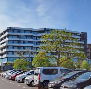 a parking lot with cars parked in front of a building at Apartment Anya in Koper
