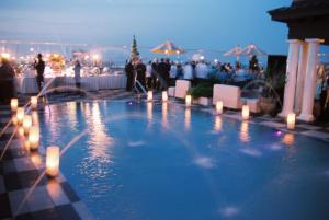a swimming pool with lights and a crowd of people at Market Pavilion Hotel in Charleston