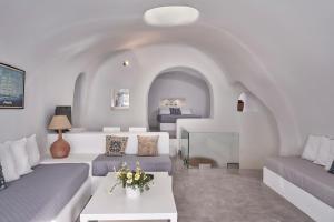 a living room with two couches and a table at Fava Eco Suites in Oia