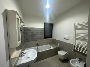 ビシェーリエにあるVilla swamyの洗面台、浴槽、トイレを備えたバスルーム