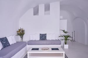 a living room with a couch and a table at Fava Eco Suites in Oia