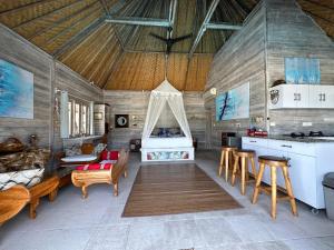 a living room with a couch and a bed at Villa Gede 888 Lembongan in Nusa Lembongan