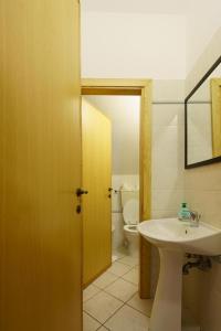 a bathroom with a white sink and a toilet at A due passi dal Mare in Riomaggiore