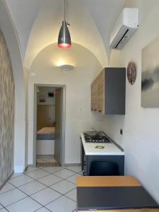 a kitchen with a sink and a stove in a room at Le stanze di Efesto in Linguaglossa