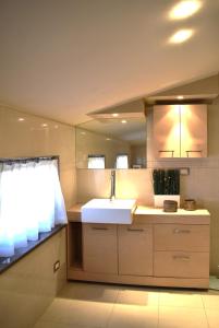 a kitchen with a sink and a mirror at Meridiana 2 in Pradamano +27 photos