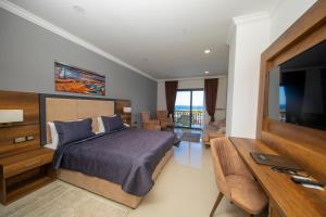 a bedroom with a bed and a flat screen tv at Mc Palace Hotel Spa & Convention in Kyrenia
