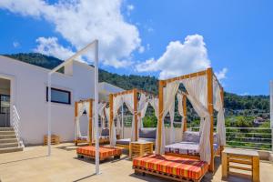 a room with two beds and a balcony with mountains at Highclere Hotel and Spa in Faralya